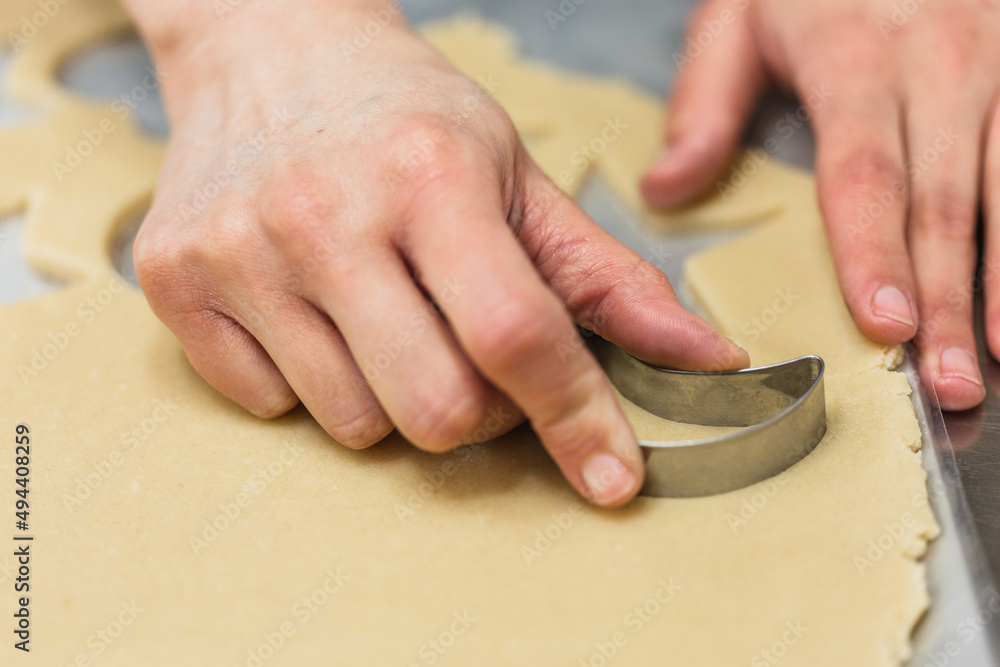 Close up view of a pastry chef cutting cookie dough. Close up view of a pastry chef cutting cookie dough.