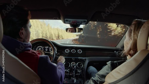 The driver of the Bentley switched the time on the control panel to the map, on the forest highway