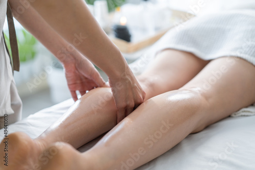 Close up of Asian young woman customer feel relex during leg massage.