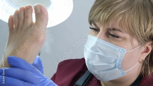master makes a hardware pedicure to a client in a beauty salon. Peeling feet. Electric pedicure machine. Close up, selective focus.