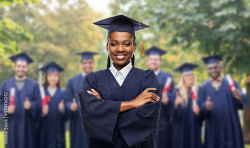 Canvastavla education, graduation and people concept - happy graduate student woman in morta