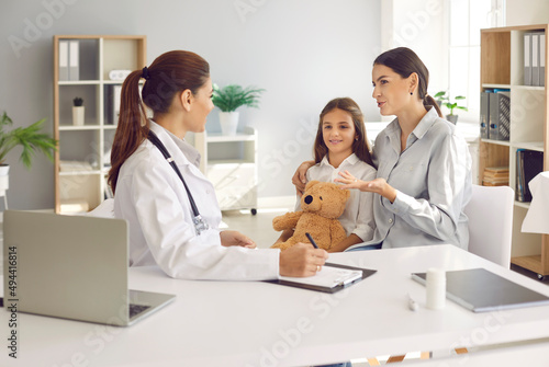 Young Caucasian mom and teen daughter child visit pediatrician in hospital or clinic. Caring mother and girl kid have consultation with female doctor or GP. Childcare, healthcare, medicine concept.