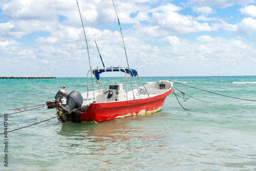 A lonely old boat is rocking on the waves. An empty fishing boat is tied to the shore with cables. Boat in the sea.