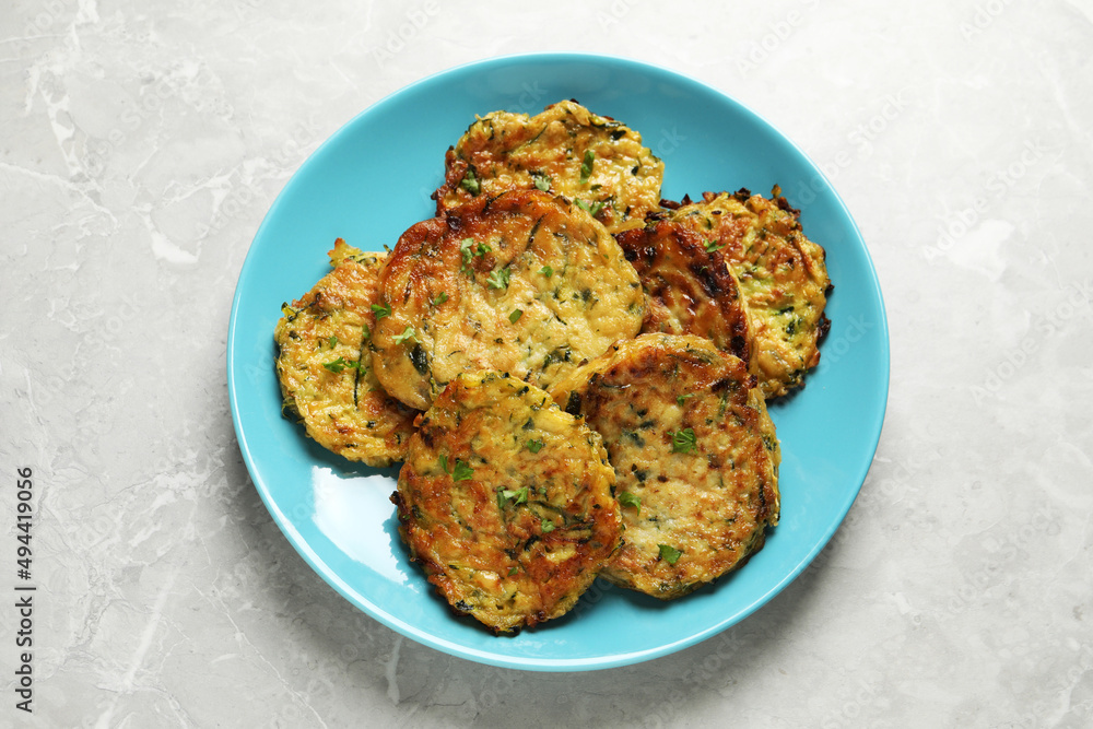 Delicious zucchini pancakes on grey table, top view Delicious zucchini pancakes on grey table, top view