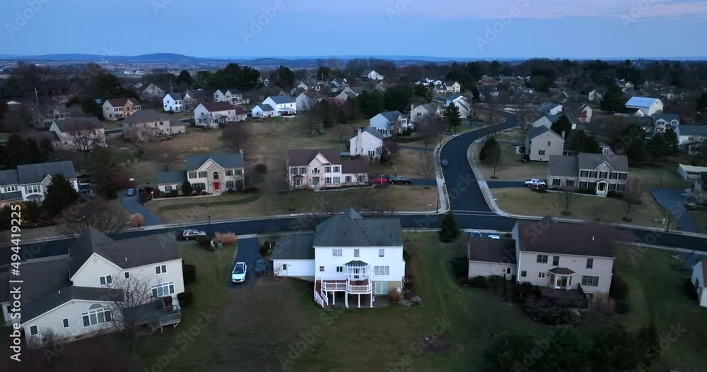 Suburban America homes at night. Winter truck shot in evening. Large two story family houses.