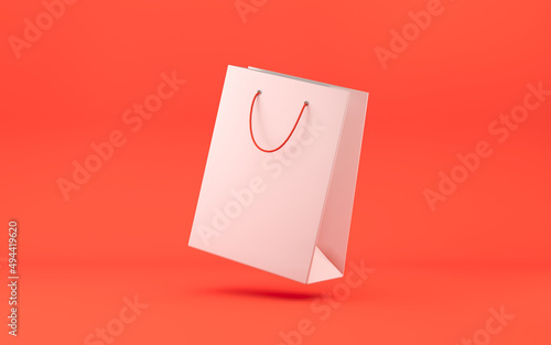 Shopping bag with ropes. White paper bag on red background. Purchase concept. 3d rendering
