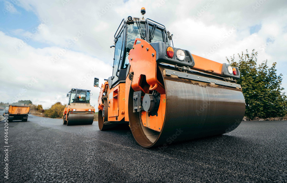 Vibratory asphalt rollers compactor compacting new asphalt pavement. Road service repairs the highway
Vibratory asphalt rollers compactor compacting new asphalt pavement. Road service repairs the highway