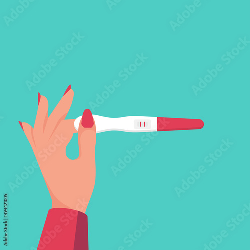 Woman holding in hand positive pregnancy test with two red stripes.