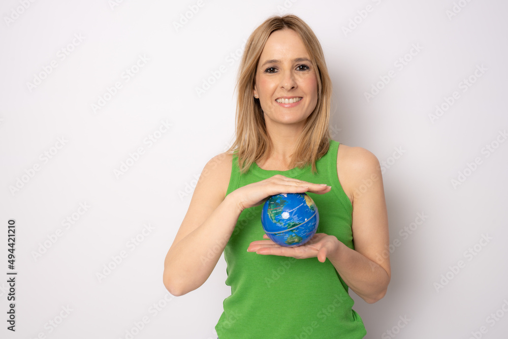 Young smiling woman holding in palms Earth world globe looking camera isolated on white background
