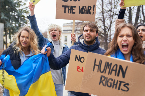 Group of young caucasian people manifesting against Ukrainian war