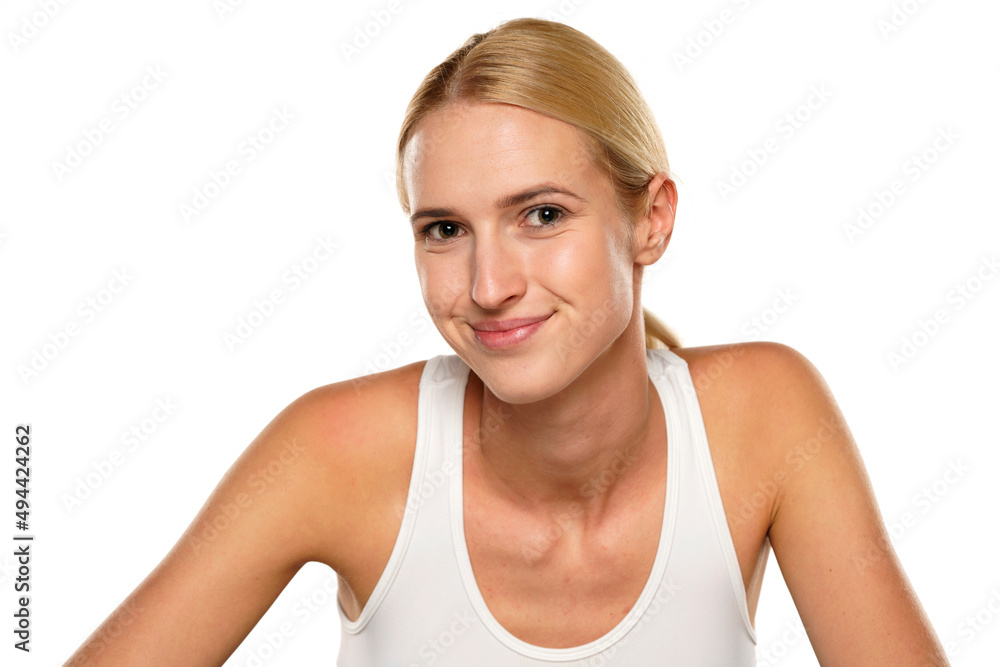 Young blond smiling woman without makeup, and with tied hair Young blond smiling woman without makeup, and with tied hair