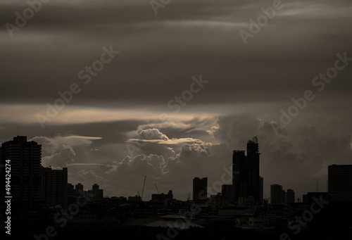 Beautiful clouds with sunshine through the cloud in the sky evening over large metropolitan city skyline. Copy space, No focus, specifically.