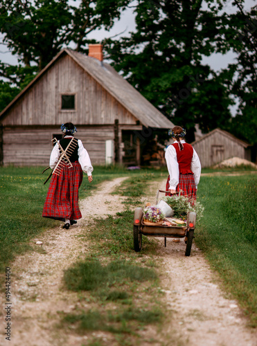 Latvian folk girls in traditional costume. Latvia summer. Symbolism of Latvia for Ligo holiday. Midsummer in Latvia. Traditional Latvian midsummer food. Celebration of Ligo in june decorating home wit