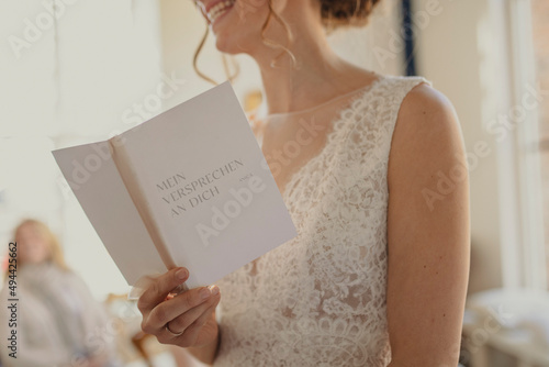woman reading a wedding programme photo