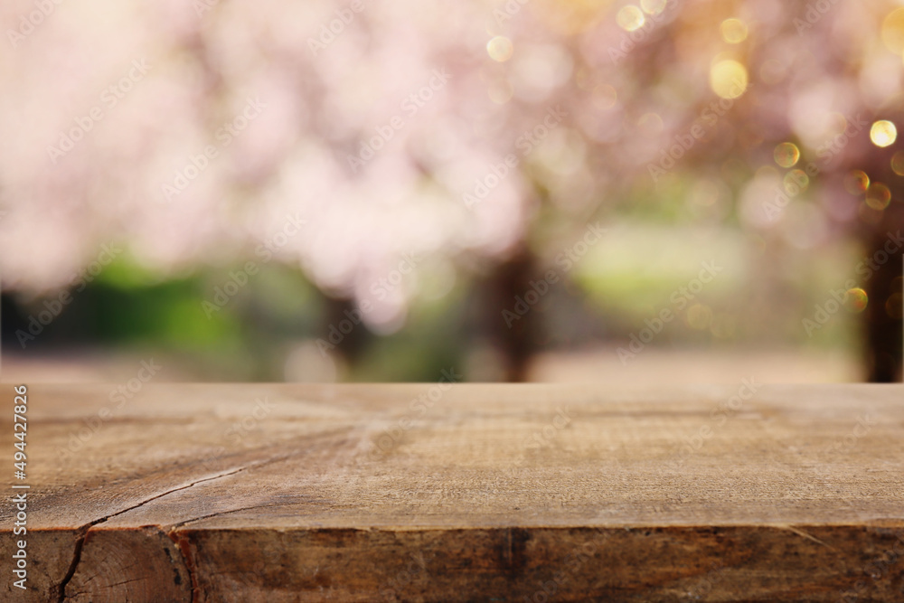 wooden table in front of spring blossom tree landscape. Product display and presentation wooden table in front of spring blossom tree landscape. Product display and presentation