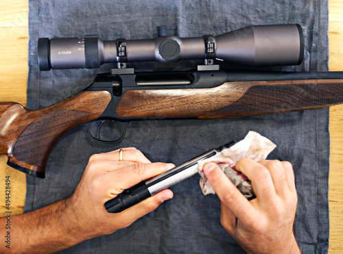 Regular maintenance is essential for every gun owner. Cropped view of a man cleaning his rifle.
