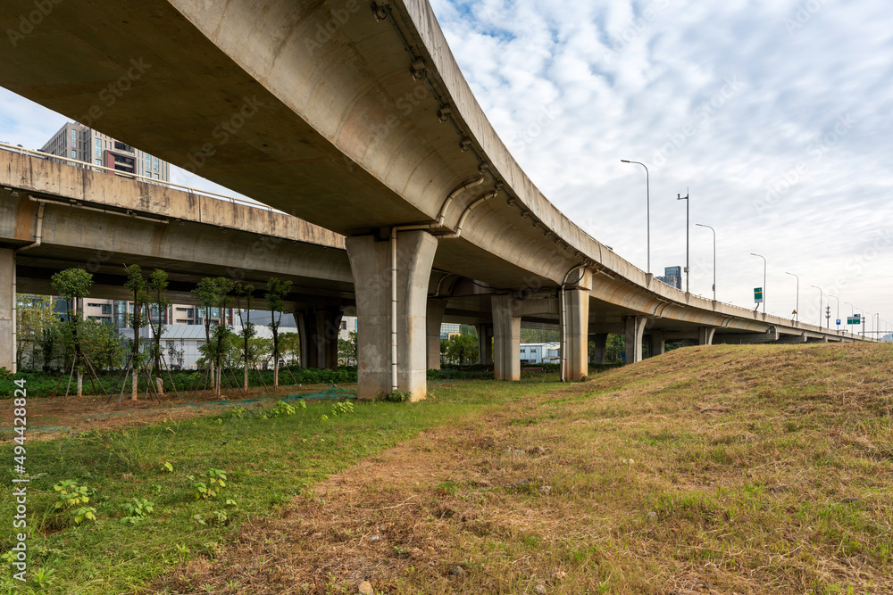 Concrete structure and asphalt road space under the overpass in the city