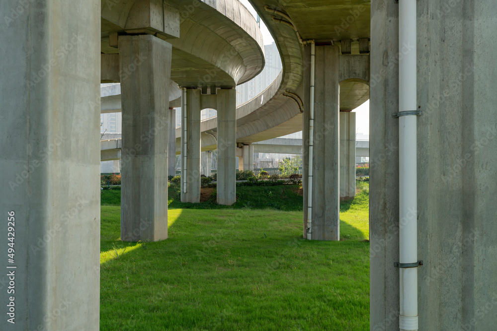 Concrete structure and asphalt road space under the overpass in the city