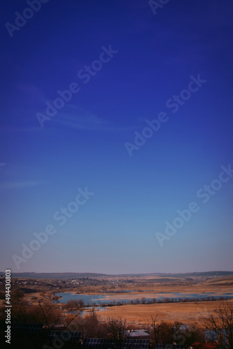 Vertical photo: landscape with lake and beautiful blue sky
