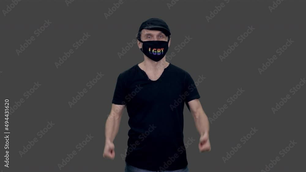 Gay man in anti covid lgbt mask looks at camera and gesturing, alpha channel included in 4k footage Gay man in anti covid lgbt mask looks at camera and gesturing, alpha channel included in 4k footage