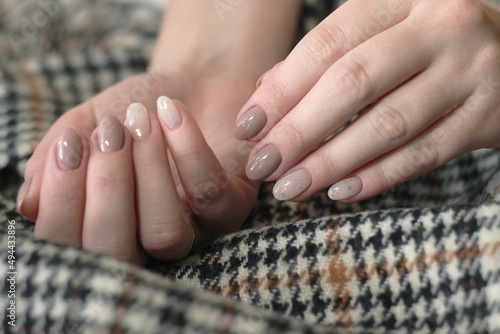 close-up cozy autumn neutral beige manicure with glitter