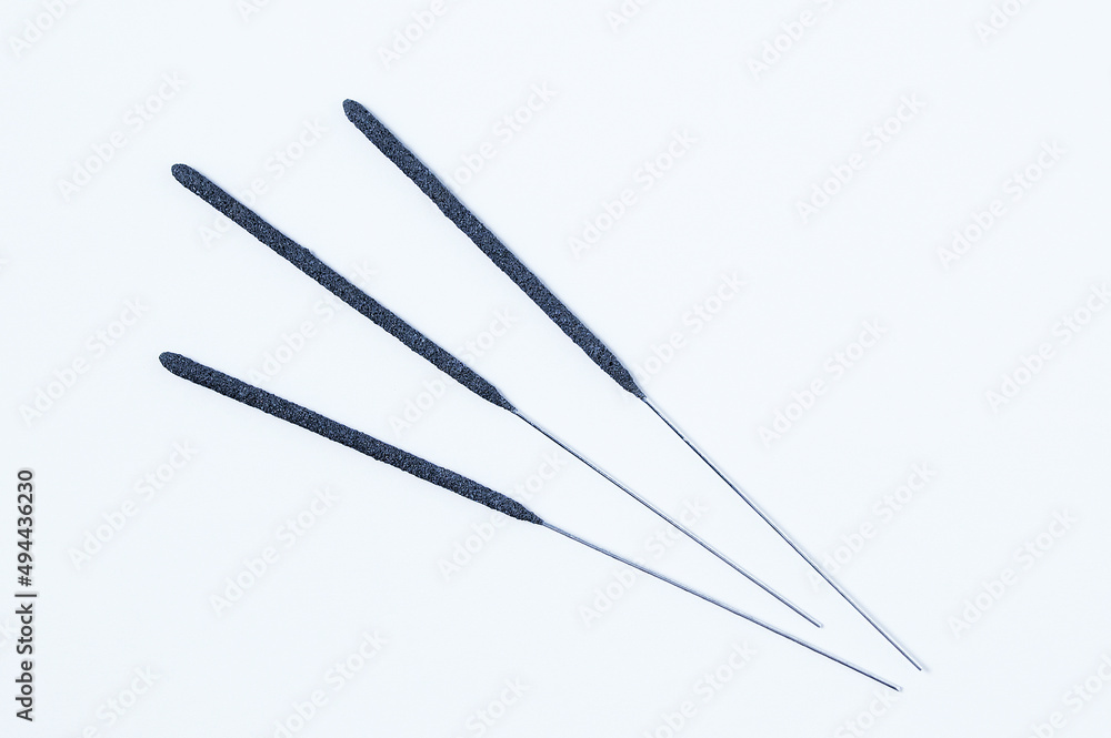 Three sticks of sparkler on white background. Three sticks of sparkler on white background.