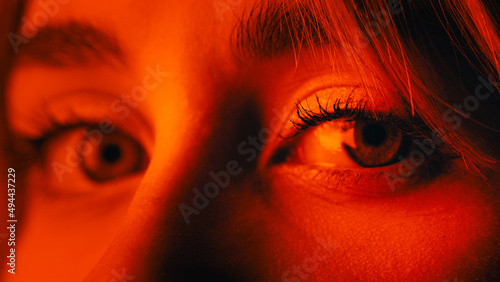 Beautiful blue eye female gaze on red light 
