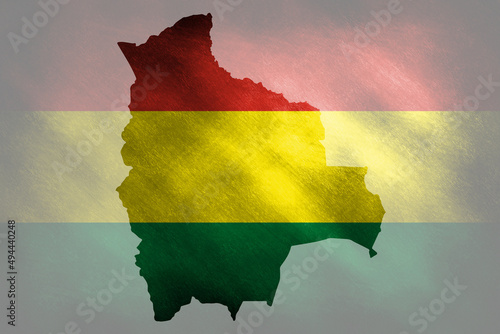 The outline of Bolivia in the national colors on a grunge background photo