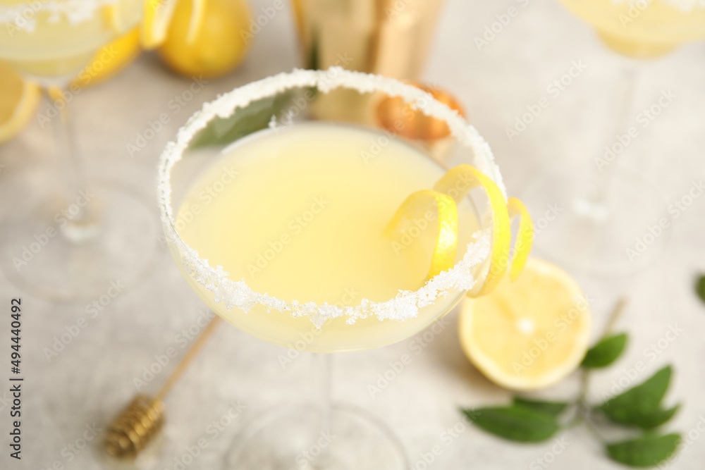 Delicious bee's knees cocktail on light grey table, closeup Delicious bee's knees cocktail on light grey table, closeup