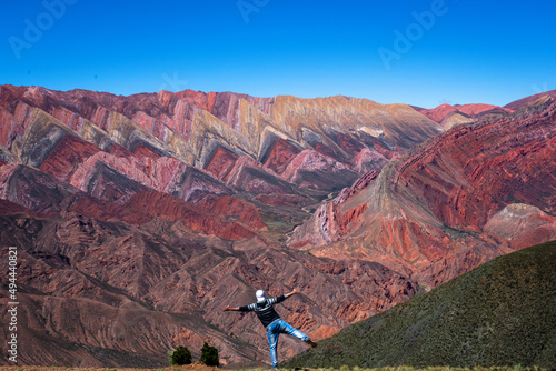 Turista disfrutando del Hornocal, cerro de los 14 colores, cerca de la  ciudad de Humahuaca photo