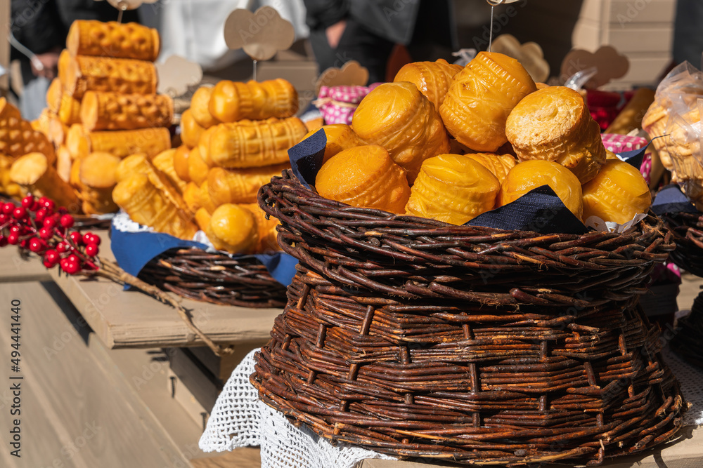 Sweet traditional Polish pastries in a wicker basket on the counter of the Easter market in Krakow outdoors on a sunny day