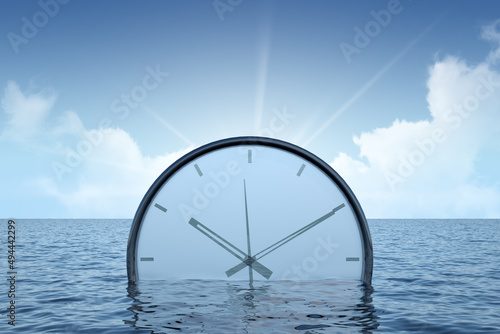 concept clock sinks into the sea