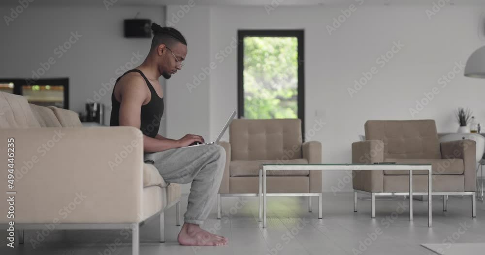 African American fitness trainer using laptop for online training with client during coronavirus pandemic. African American fitness trainer using laptop for online training with client during coronavirus pandemic.