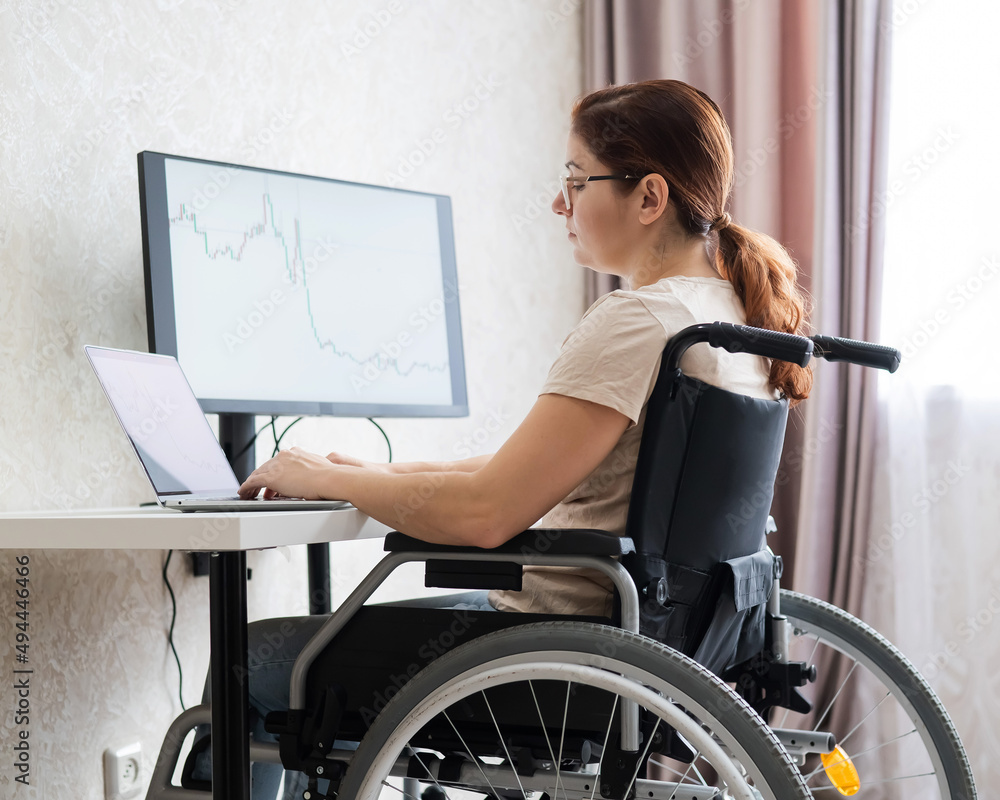 Caucasian woman on wheelchair working on laptop. Caucasian woman on wheelchair working on laptop.