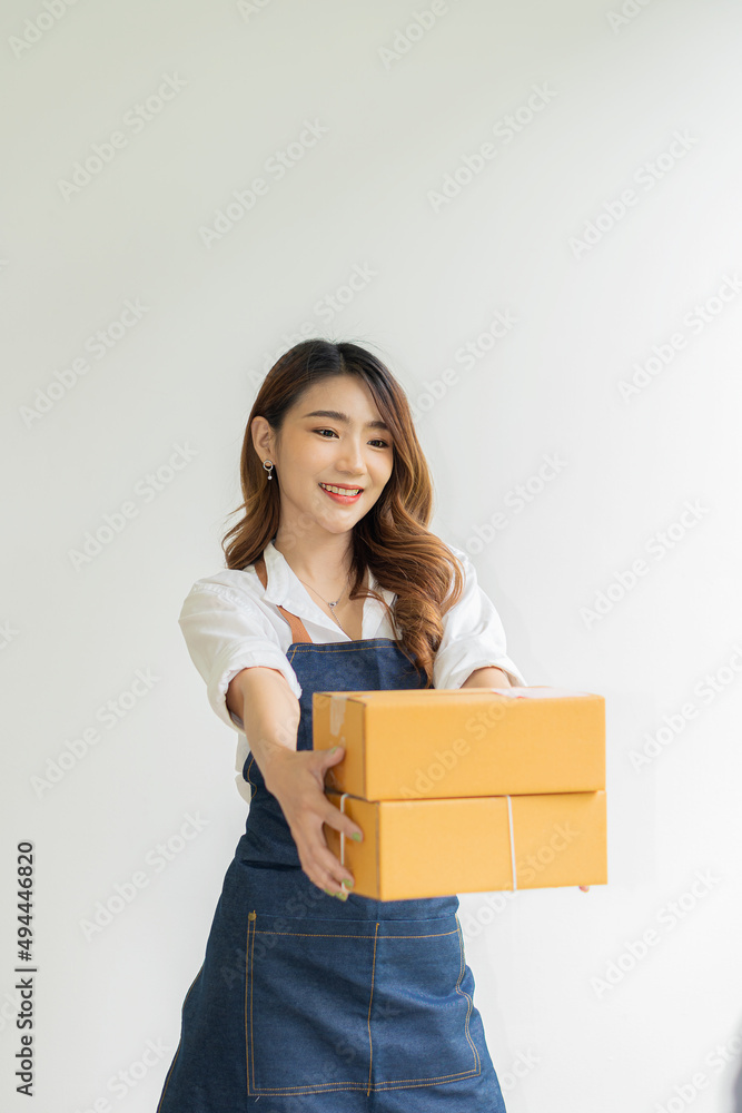 Portrait of a small business startup, SME owner, female entrepreneur holding a box on white background, online purchase concept to prepare a box. Sell to customers. SME business online Portrait of a small business startup, SME owner, female entrepreneur holding a box on white background, online purchase concept to prepare a box. Sell to customers. SME business online