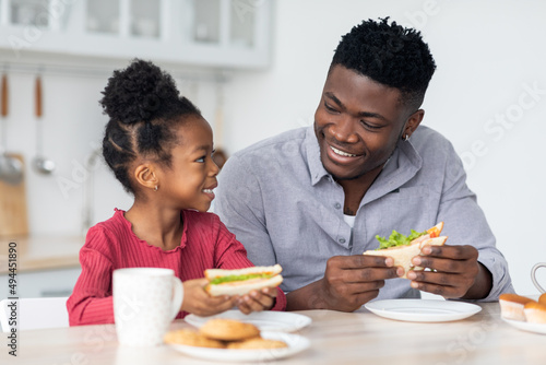 Portrait of loving black family having lunch at home