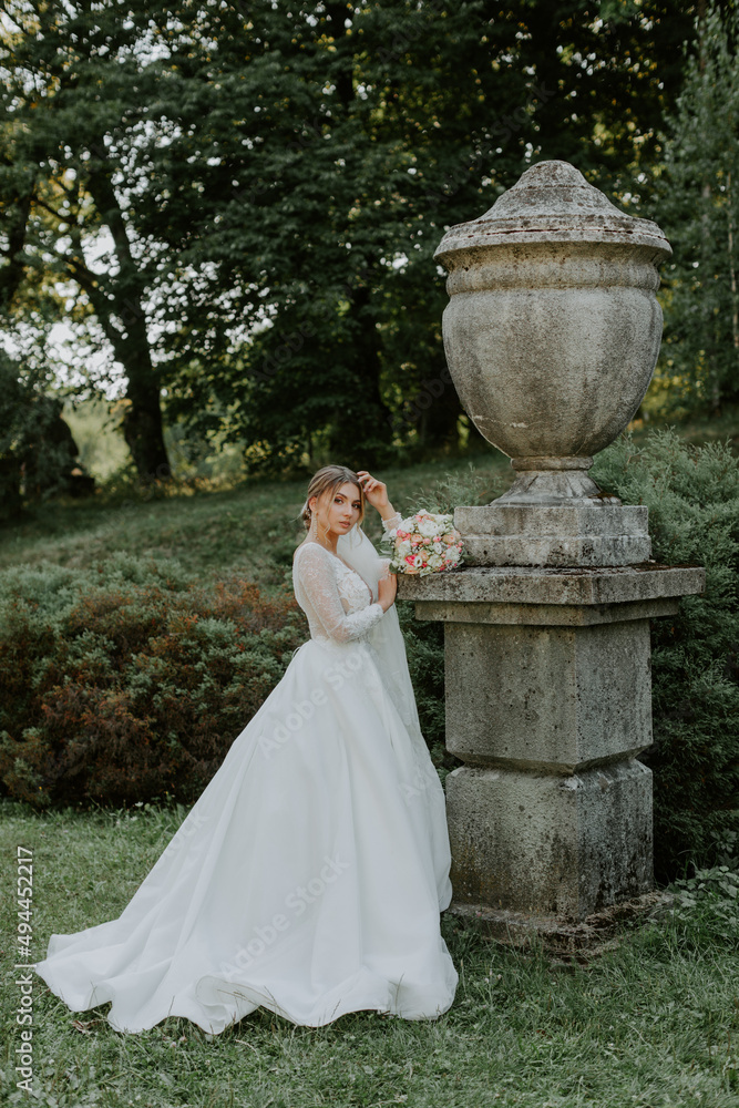 Beautiful bride in fashion wedding dress on natural background.The stunning young bride is incredibly happy. Wedding day. .A beautiful bride portrait in the forest.