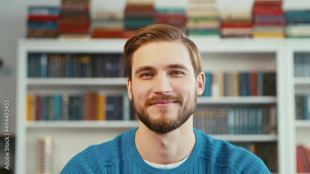 Smiling young teacher on the background of books Smiling young teacher on the background of books