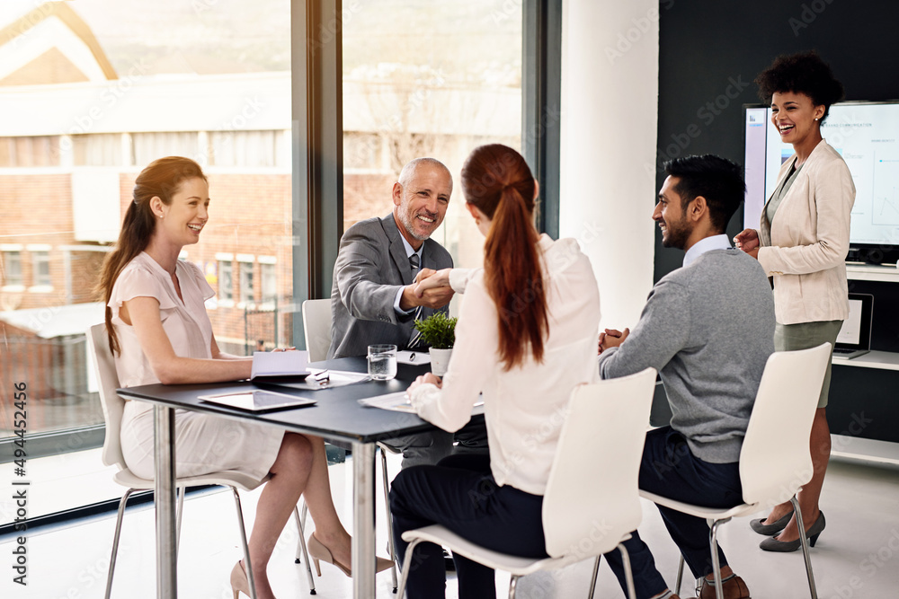 Showing some support and appreciation to the team. Cropped shot of businesspeople shaking hands during a meeting in a modern office. Showing some support and appreciation to the team. Cropped shot of businesspeople shaking hands during a meeting in a modern office.