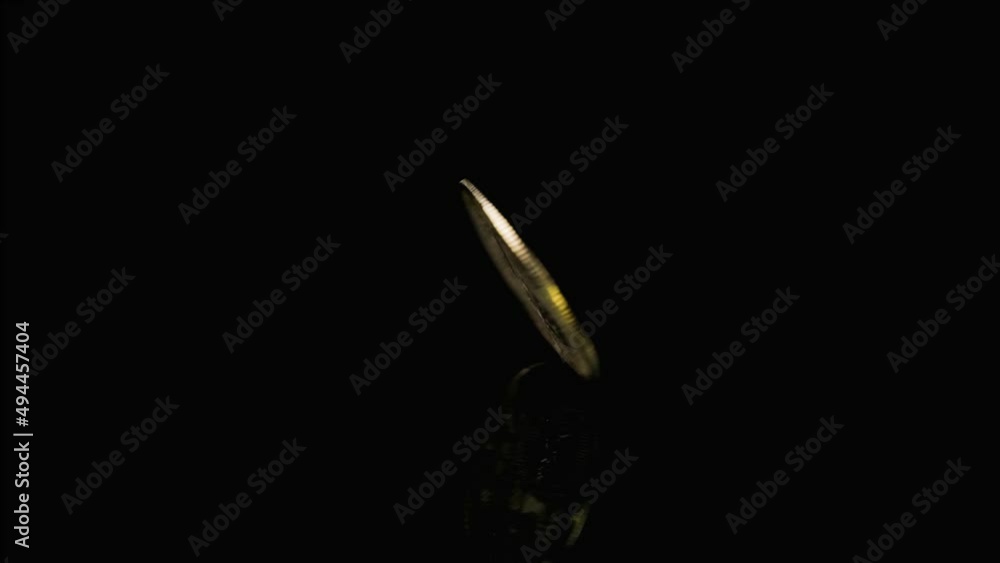 Golden bitcoin spinning until stop over dark reflective background, Cryptocurrency concept Golden bitcoin spinning until stop over dark reflective background, Cryptocurrency concept