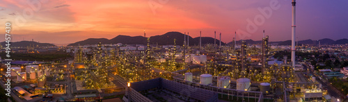 Aerial view. Oil refinery factory and oil storage tank at twilight and night. Banner panorama background 