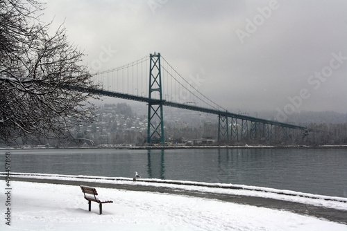 Lions Gate Bridge over a river on a cloudy day in Vancouver, British Columbia, Canada photo