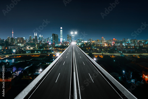 Top view of Highway overpass with beautiful city background. night scene .
