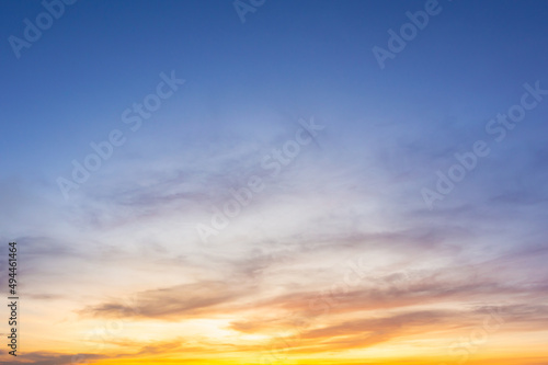 Beautiful Vivid sky painted by the sun leaving bright golden shades.Dense clouds in twilight sky in winter evening.Image of cloud sky on evening time.Evening Vivid sky with clouds. © Chalermwoot