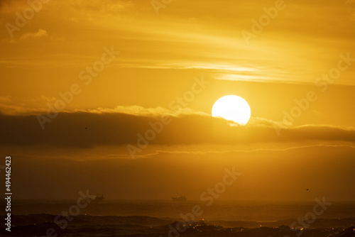 Beautiful shot of a bright sunset sky over a beach in Van Stadens, South Africa photo