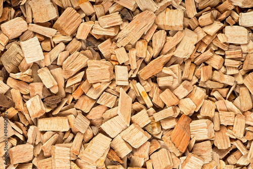 Pile of wood chips as background  top view. Wooden chips for smoking meat and fish.