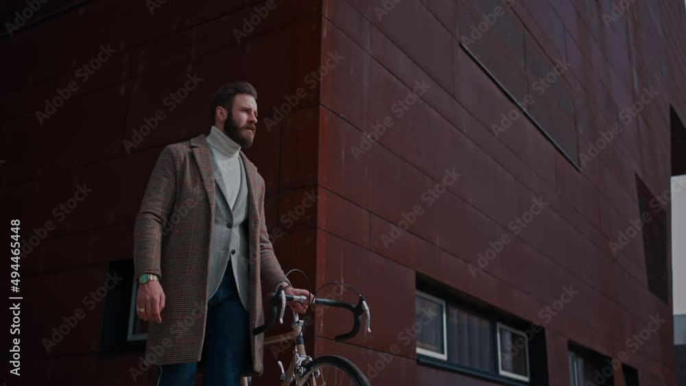 Young man with bicycle going to work.Commuting to work. Creative businessman in a modern business area. Young man with bicycle going to work.Commuting to work. Creative businessman in a modern business area.