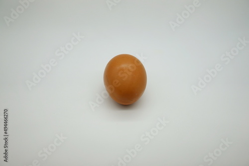 Shiny brown-shelled chicken eggs placed vertically on a white background. organic eggs on the table 