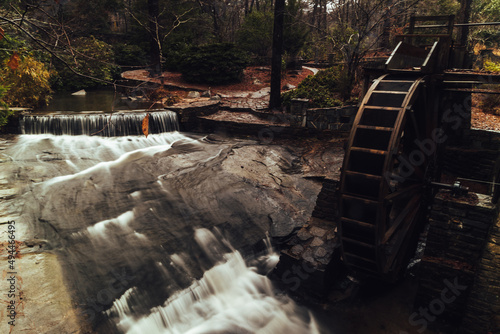 Fotografia, Obraz Beautiful dark wallpaper of a Water Wheel in the forest with waterfall near the