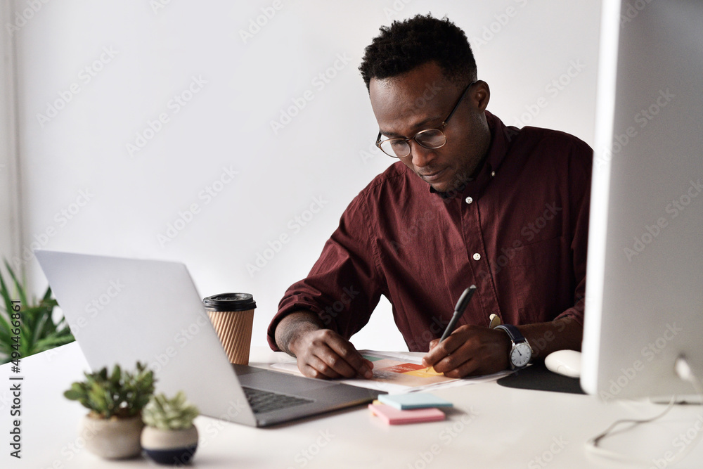 I have to take notes before I forget. Cropped shot of a handsome young businessman sitting alone and making notes while using his laptop in the office. I have to take notes before I forget. Cropped shot of a handsome young businessman sitting alone and making notes while using his laptop in the office.